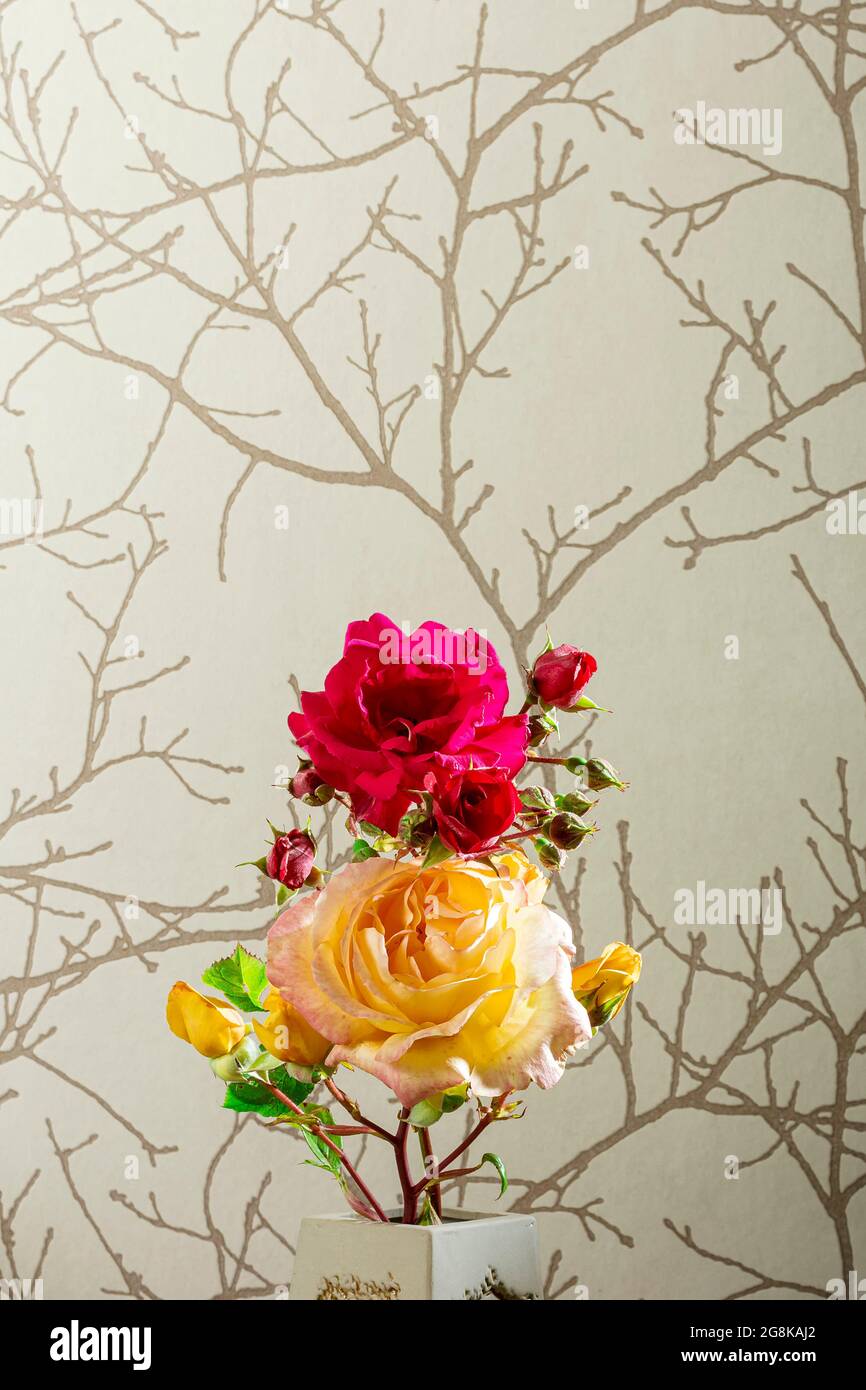 Photo of a bouquet of natural flowers with a red rose and a yellow rose on a brown paper background.The photo has copy space to put the text or whatev Stock Photo