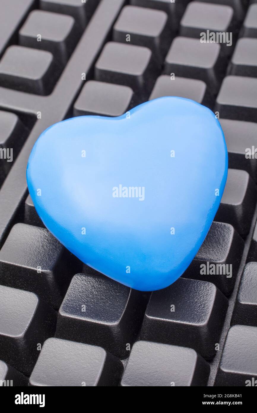 Blue heart + black Qwerty keyboard for Blue Monday, feeling gloomy /  dispirited, poor office morale, being dumped online, Covid lockdown mental  blues Stock Photo - Alamy