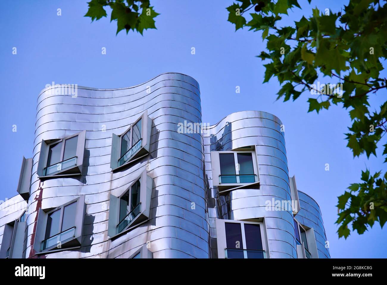 A modern art building designed by the American star architect Frank O. Gehry with reflecting stainless steel facade. Location: Düsseldorf Medienhafen. Stock Photo