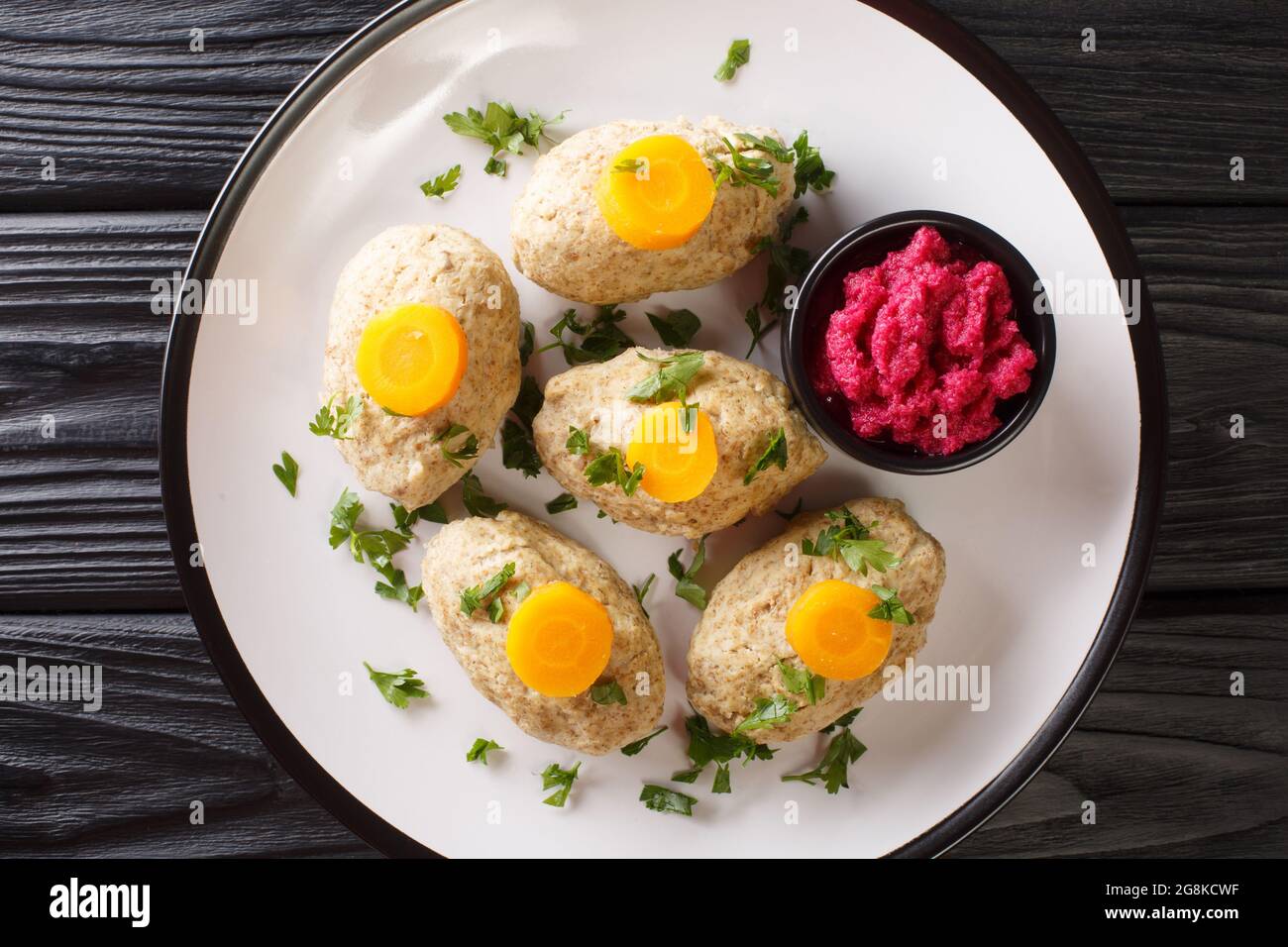 Homemade tasty Gefilte Fish for Passover closeup in the plate on the table. Horizontal top view from above Stock Photo