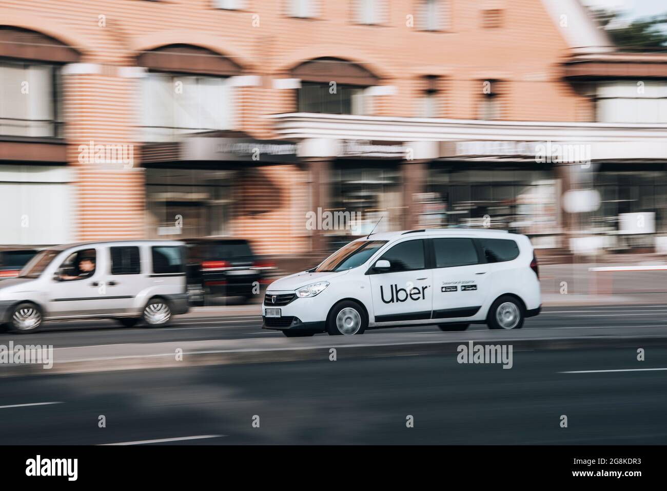 Ukraine, Kyiv - 16 July 2021: White Renault Dokker Taxi Uber car moving on the street. Editorial Stock Photo