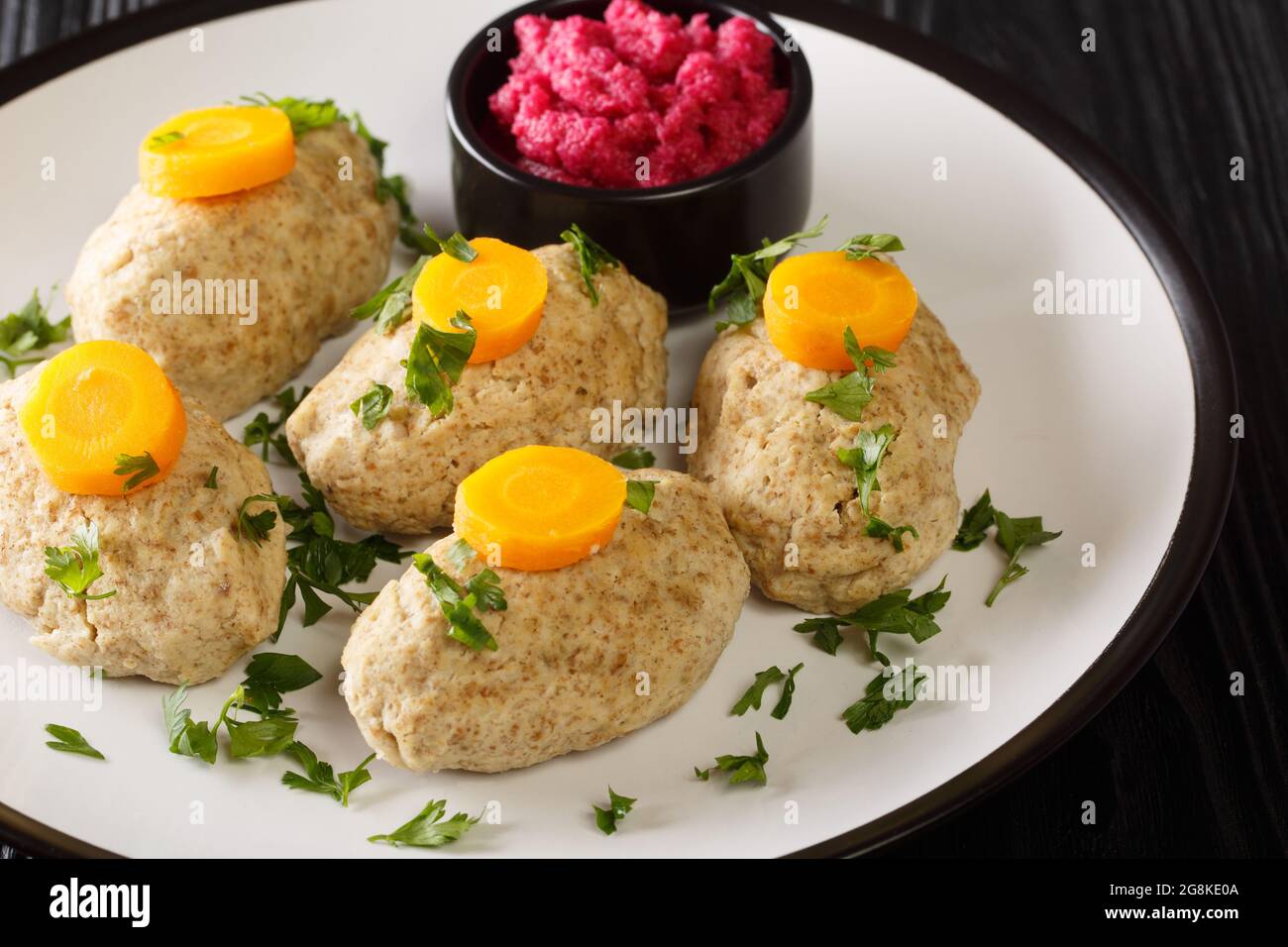 Homemade tasty Gefilte Fish for Passover closeup in the plate on the table. Horizontal Stock Photo
