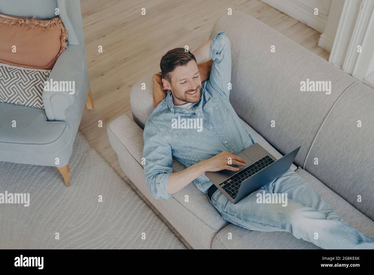 Young business company worker in casual clothes relaxing after successful online presentation Stock Photo