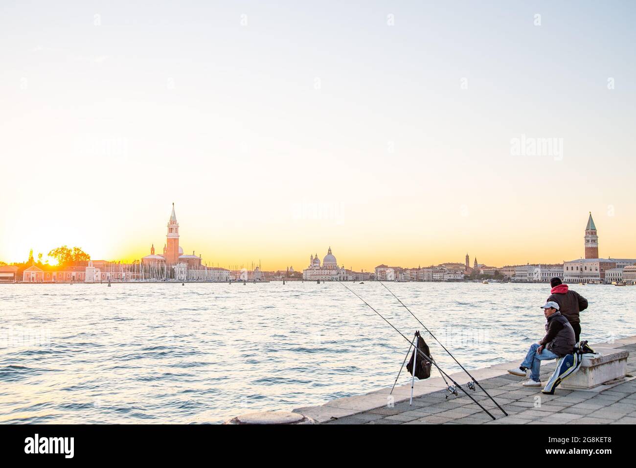 VENICE, ITALY - Jul 31, 2018: calm fisherman enjoying the sunset in Venice, Biennale di Venezia, panoramic view Stock Photo