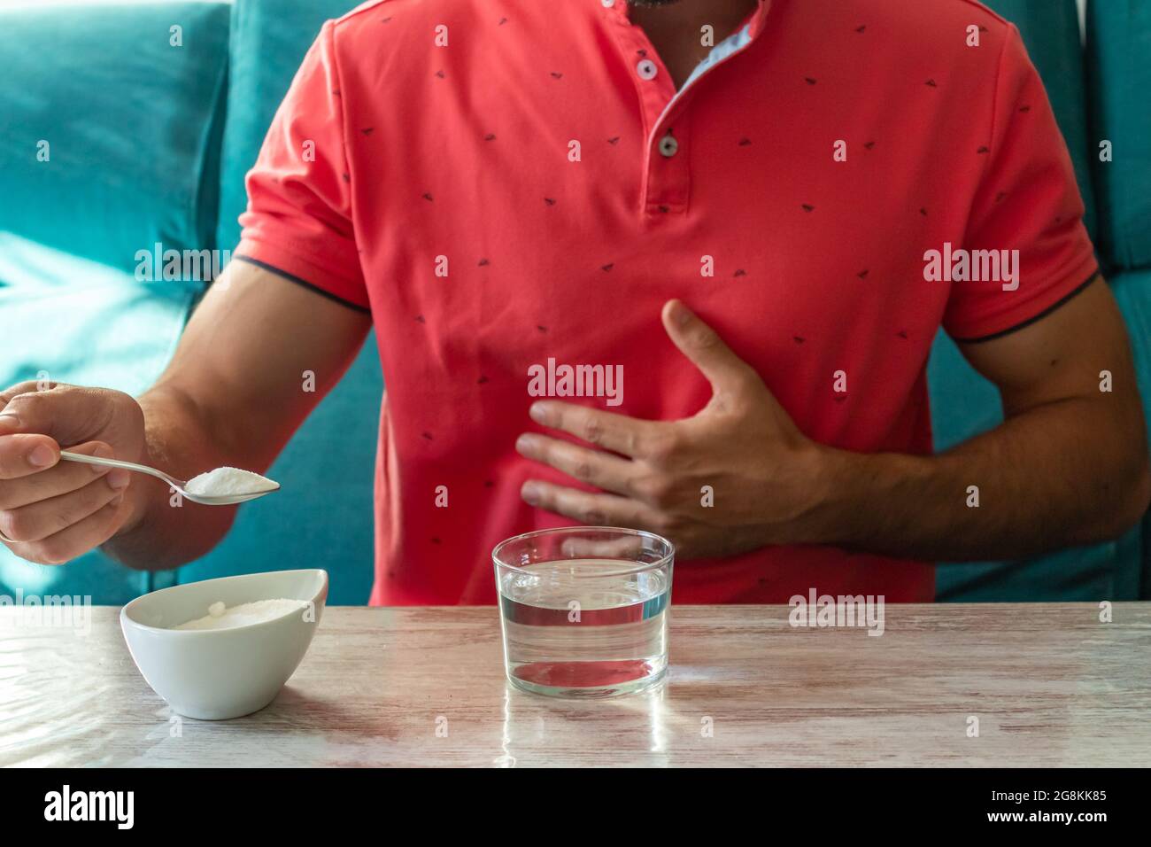 Caucasian man with stomach ache preparing fruit salt Stock Photo Alamy