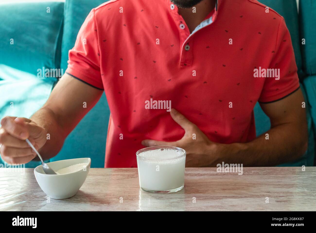 Caucasian man with stomach ache preparing fruit salt Stock Photo Alamy