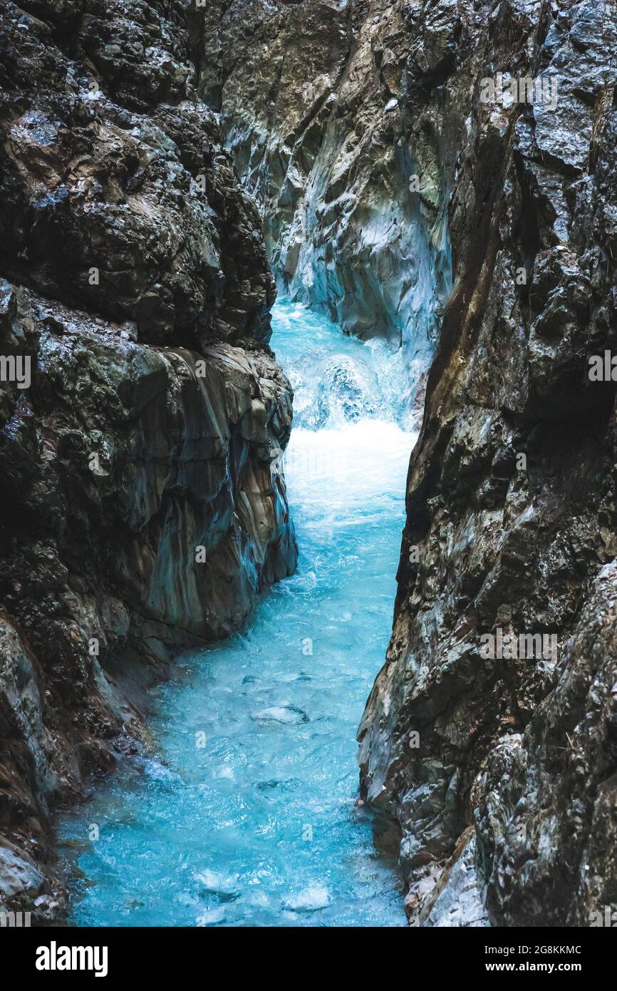Scenic view of a river with clear blue water flowing among boulders and ...