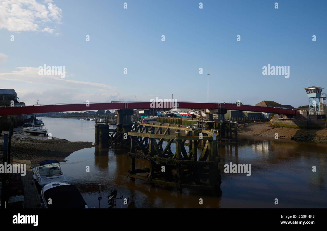Red foot and bicycle bridge seen in Littlehampton, West Sussex, England, UK. Stock Photo