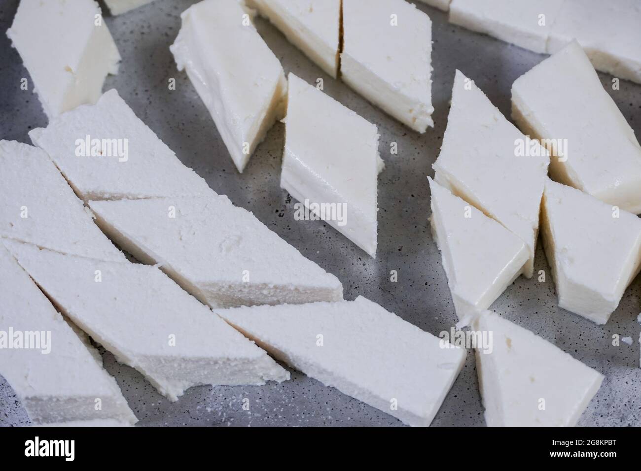 Cubes of fresh white paneer on a plate Stock Photo