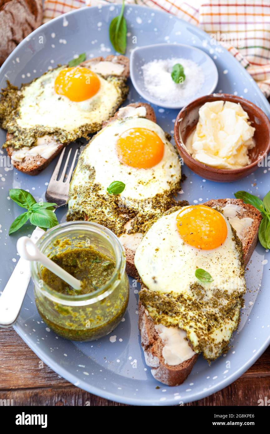 Pesto eggs, eggs, fried in basil pesto , sunny side up Stock Photo Alamy