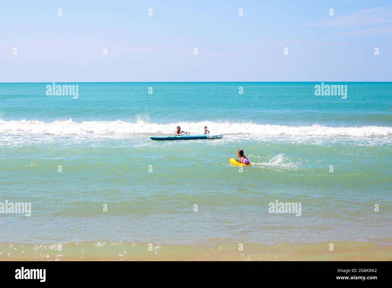 Anapa, Russia-07.07.2021: Tourists swim in the sea and paddle board. Stand up paddle boarding and practice. Stock Photo