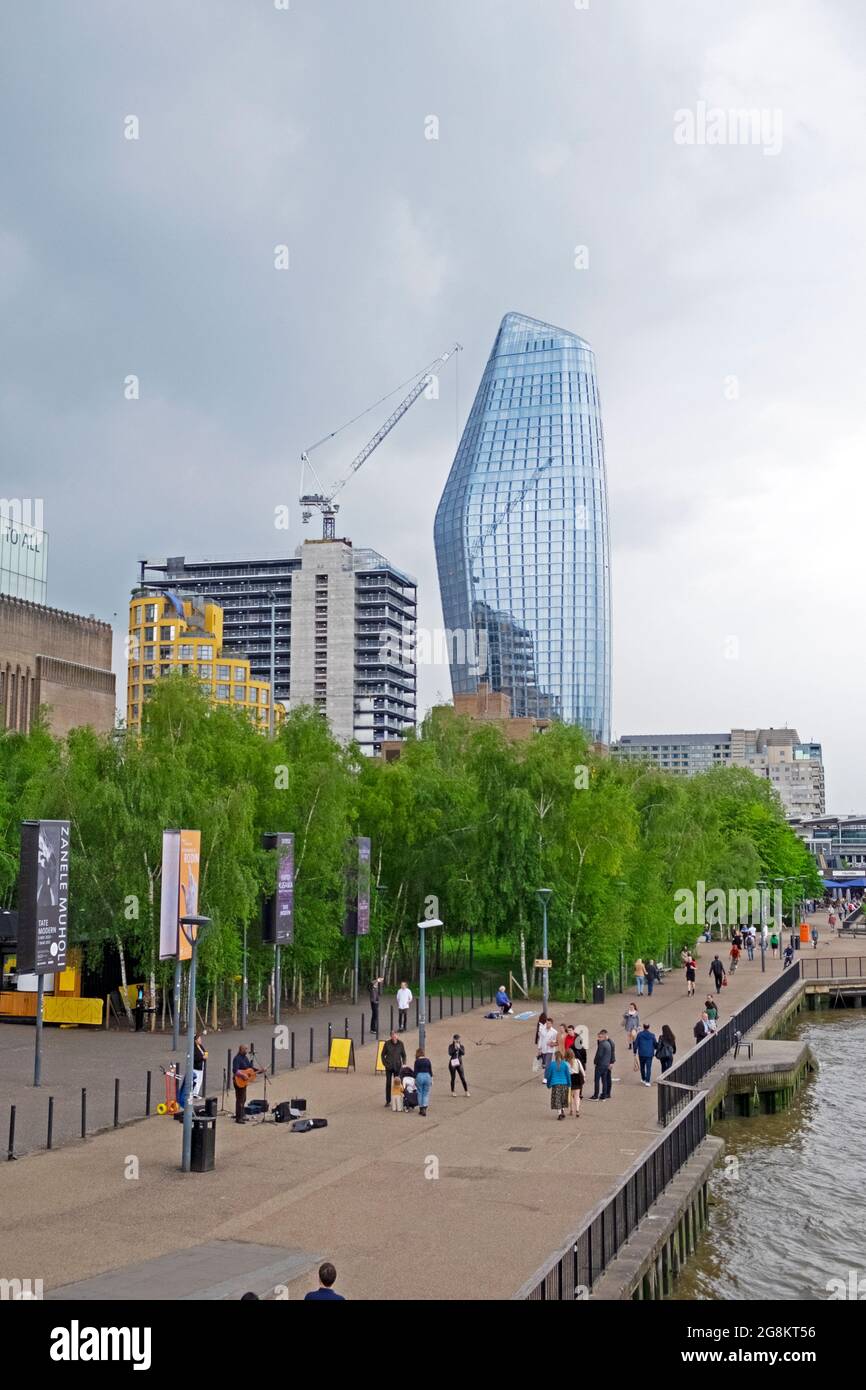 Vertical view of One Blackfriars tower and people walking along the River Thames path after covid restrictions eased in South London UK   KATHY DEWITT Stock Photo