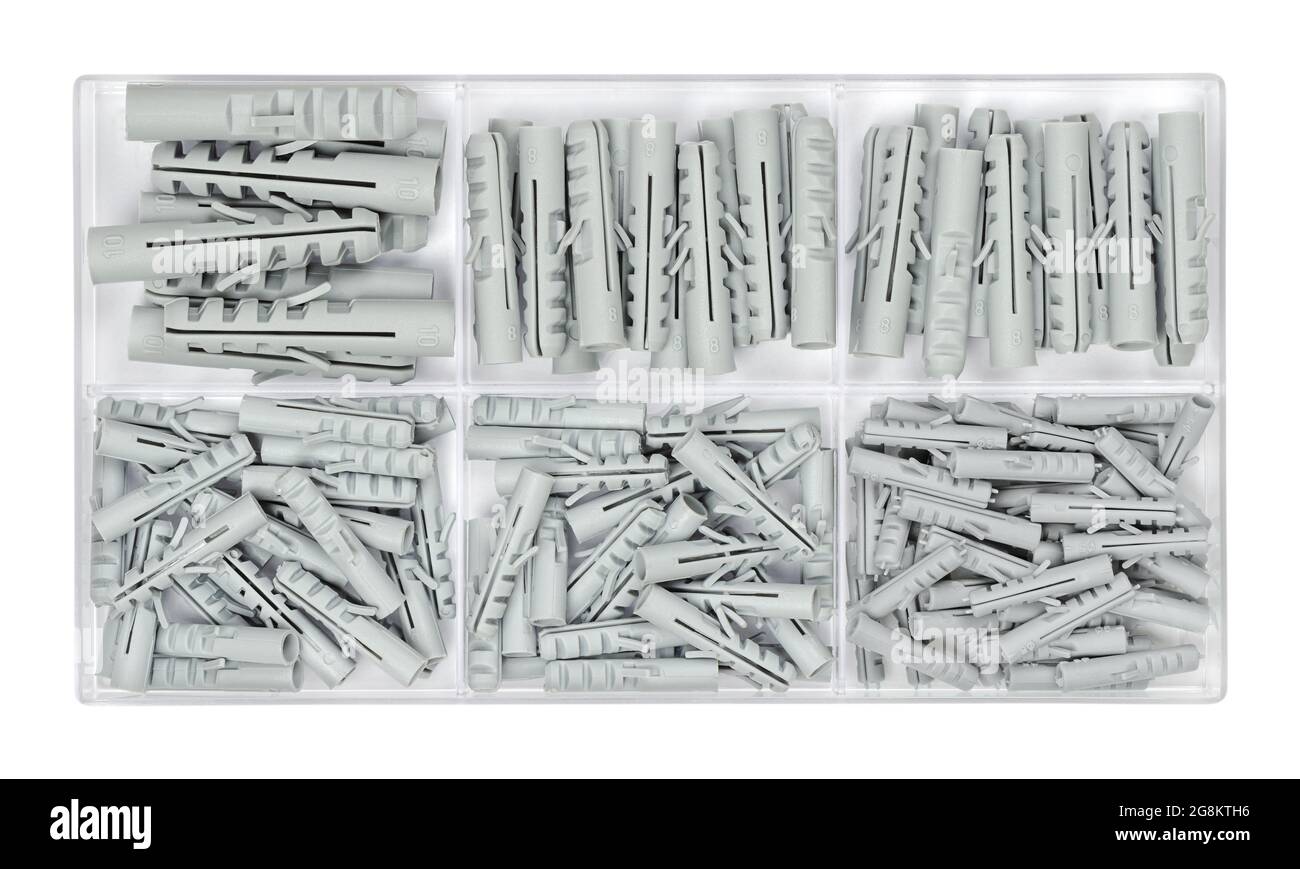 Set of wall plugs in a clear plastic box. Assorted gray anchors or rawlplugs in a container. Plastic insert, allow a screw to be fitted into a wall. Stock Photo