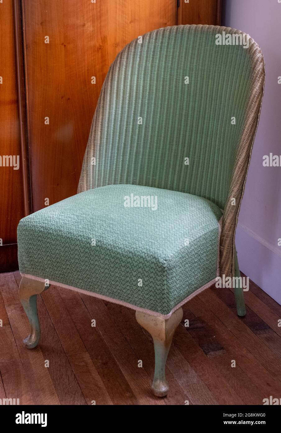 Original vintage green Lloyd Loom wicker rattan chair Stock Photo - Alamy