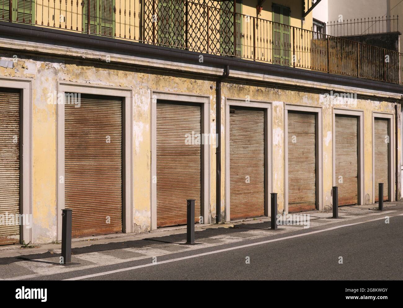 Row of shops with shutters down, Italy Stock Photo