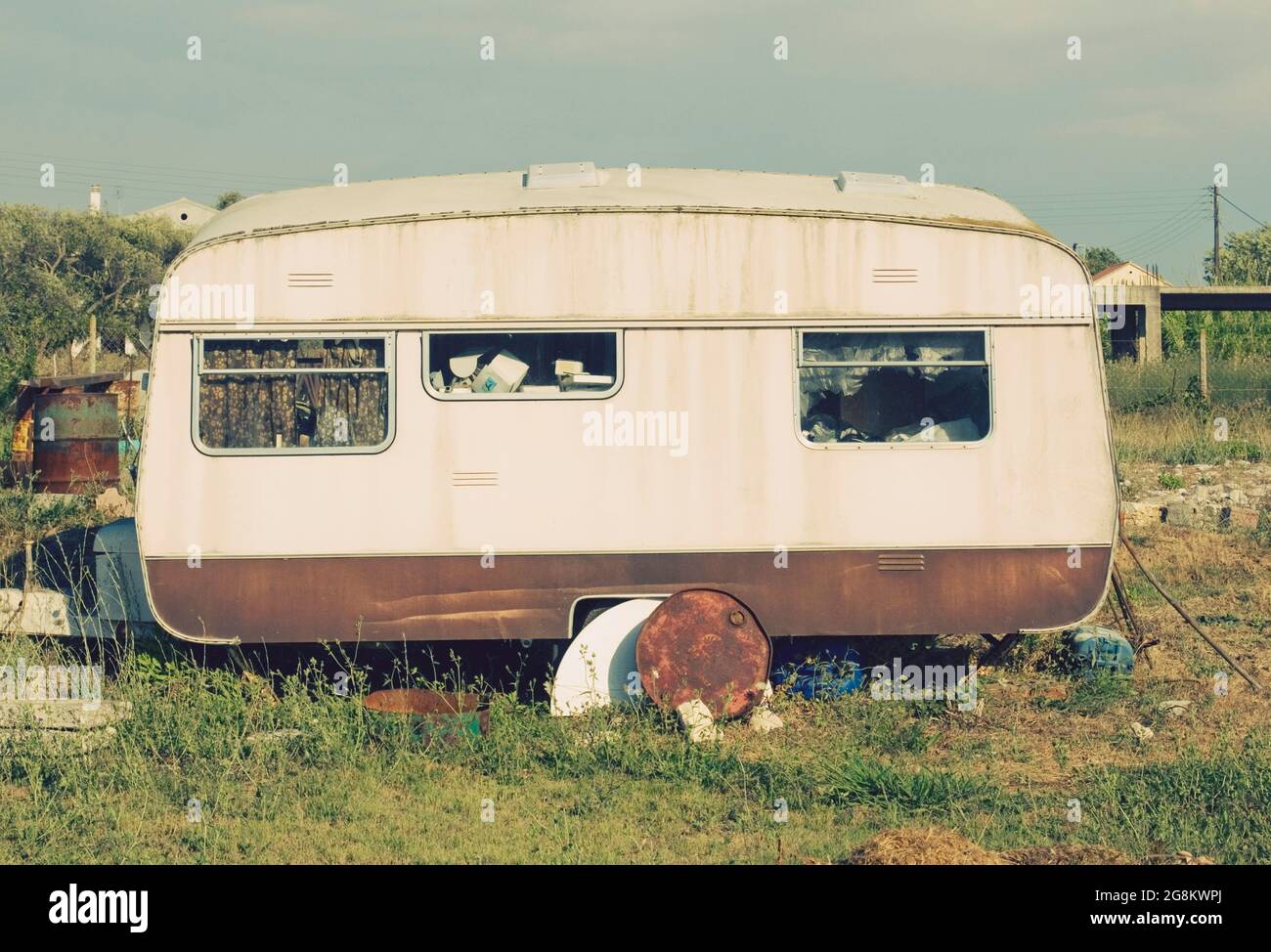 an old abandoned trailer in field Stock Photo
