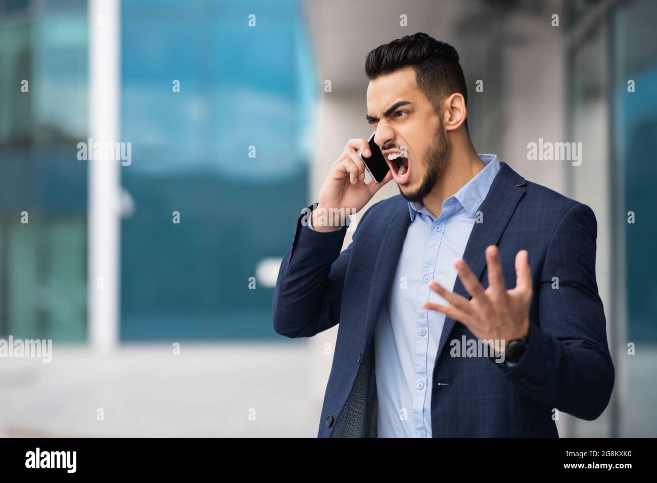 Furious arab man in suit having phone conversation Stock Photo Alamy