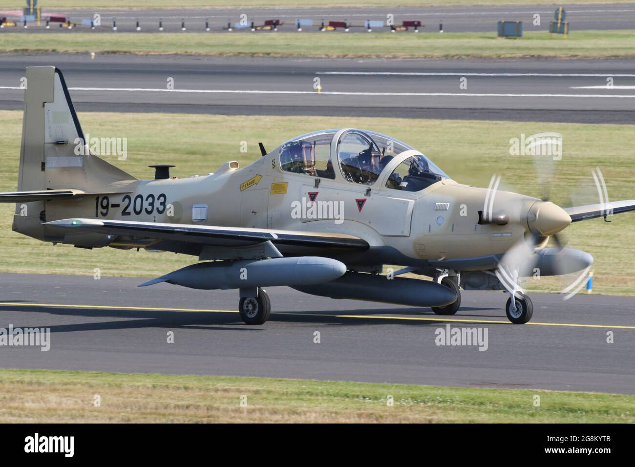 One of six Embraer A-29B Super Tucanos destined for the Nigerian Air Force (NAF), on departure from Prestwick International Airport on 20 July 2021. The aircraft was on a delivery flight from the USA to Nigeria, and wore a temporary US military serial (19-2033) for the flight. This particular airframe will become NAF845 in Nigerian Air Force service. Stock Photo