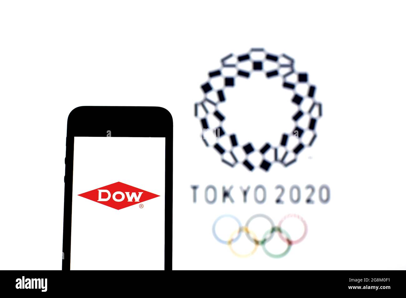 Barcelona, Catalonia, Spain. 20th July, 2021. In this photo illustration a The Dow Chemical Company logo seen displayed on a smartphone with a Tokyo 2020 Olympic Games logo in the background. (Credit Image: © Thiago Prudencio/DAX via ZUMA Press Wire) Stock Photo