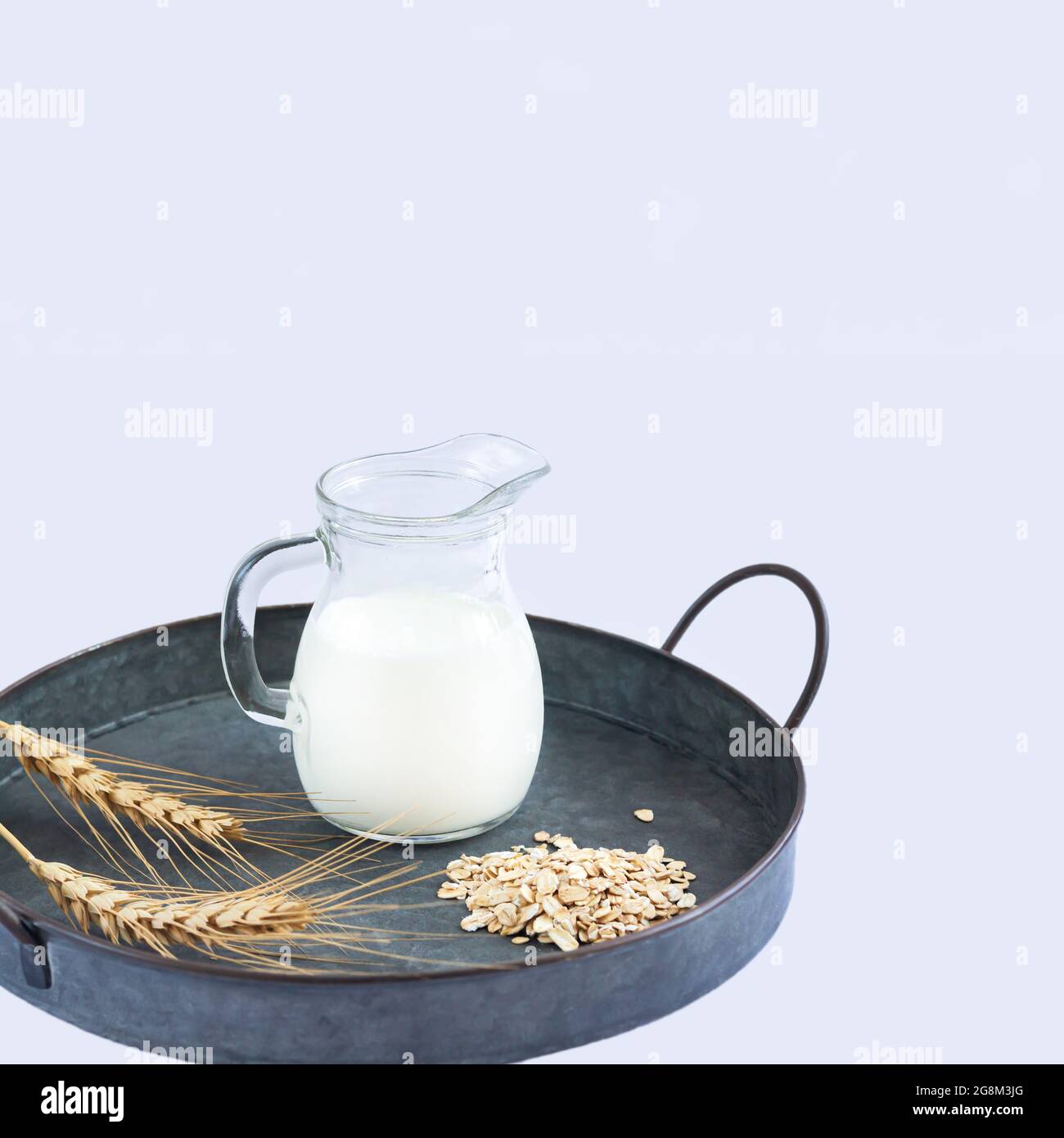 Vegan oat milk, non dairy alternative milk in glass jug Stock Photo
