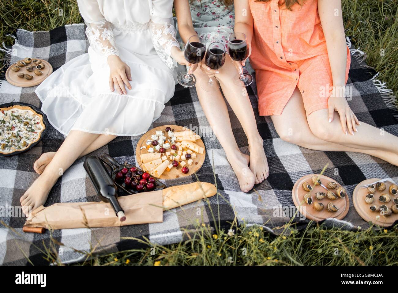 girls, sitting on a blanket on nature 