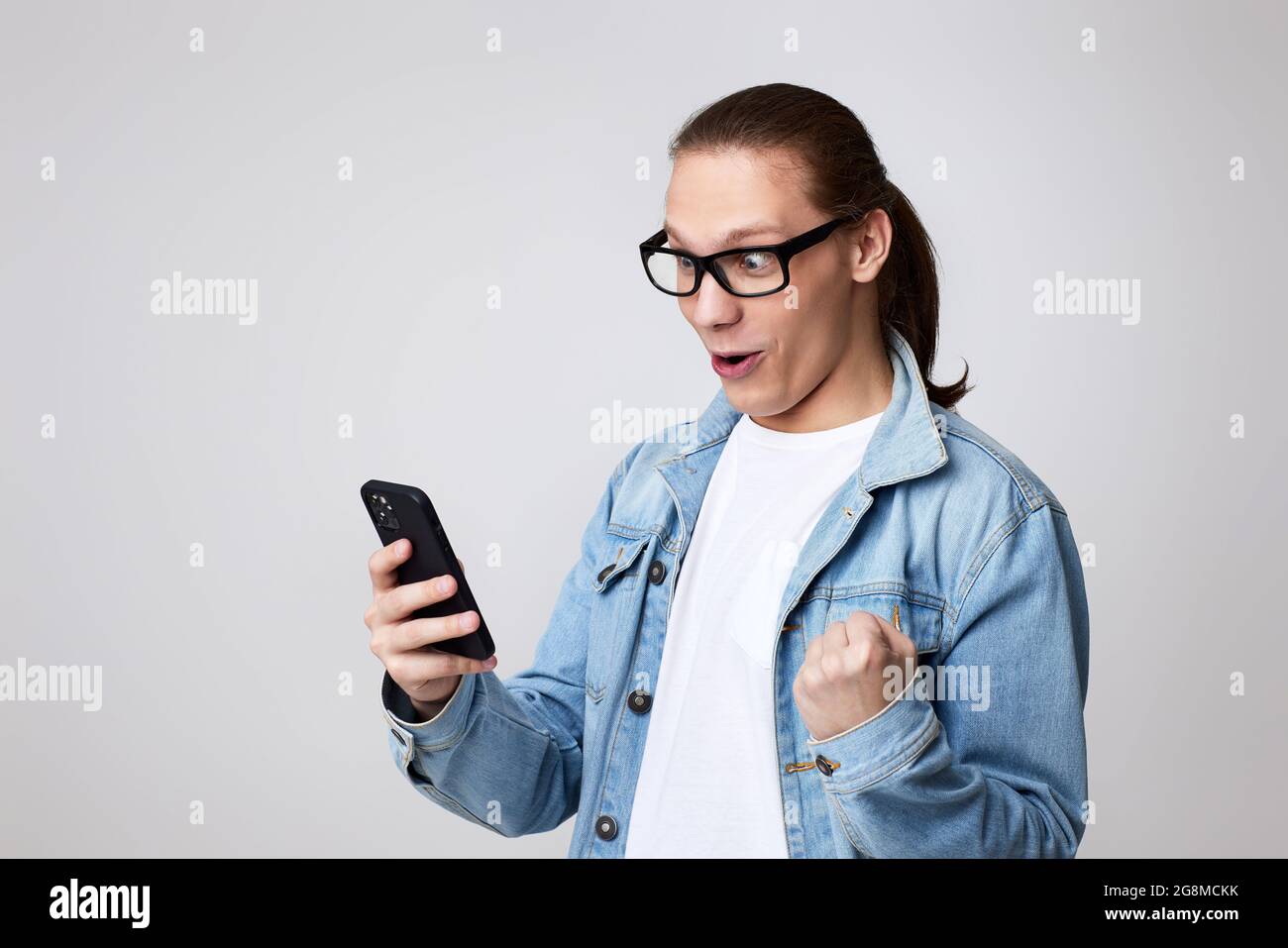 young man in glasses using smart phone Stock Photo