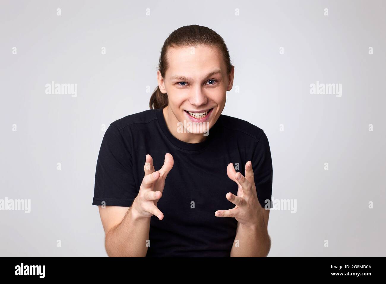 caucasian young handsome man in t-shirt scheming something Stock Photo