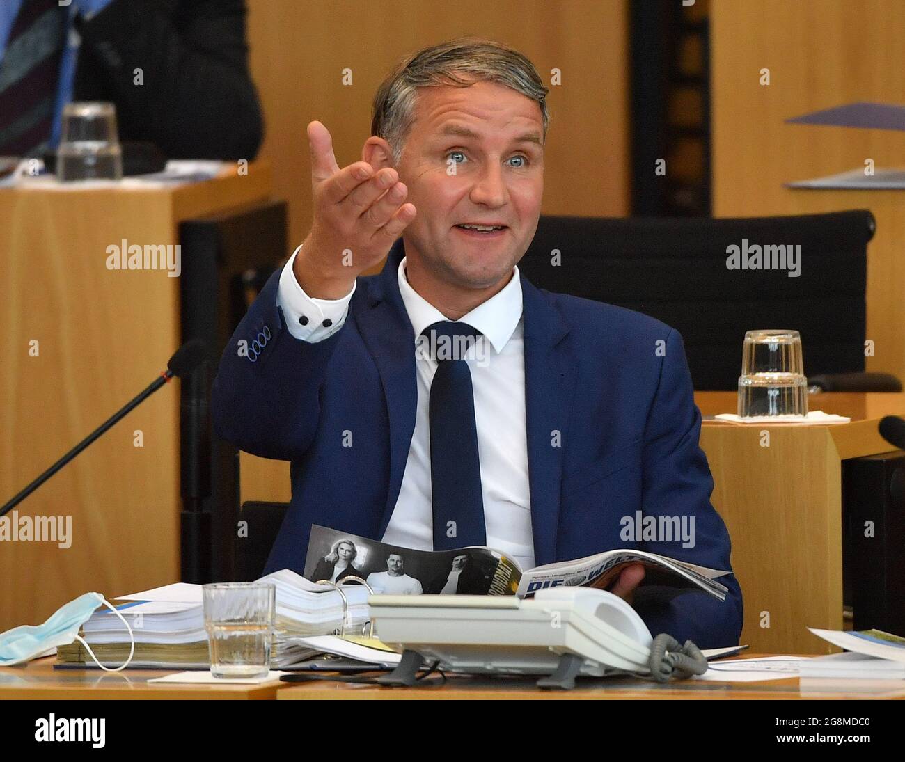 Erfurt, Germany. 21st July, 2021. Björn Höcke, AfD parliamentary group leader, sits in the plenary chamber of the Thuringian state parliament and gestures. The Thuringian state parliament is to decide on the vote of no confidence in Thuringia's prime minister initiated by the AfD on July 23. The item was put on the agenda of the plenary session without any objection from the deputies. The AfD has nominated its parliamentary group leader Björn Höcke as an opposing candidate to the current prime minister. Credit: Martin Schutt/dpa-Zentralbild/dpa/Alamy Live News Stock Photo