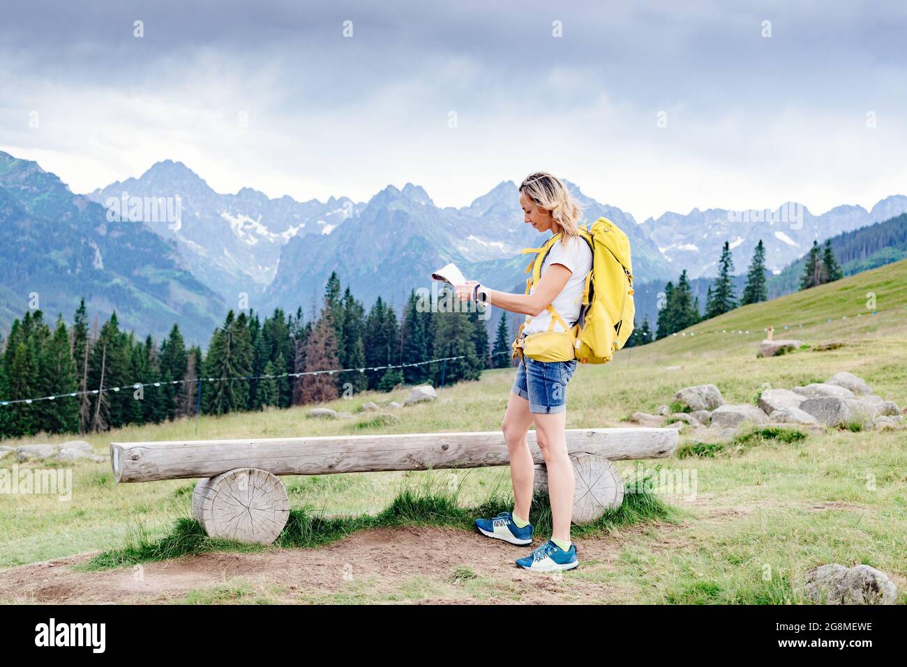 Adventurous woman navigating with a topographic map in beautiful 