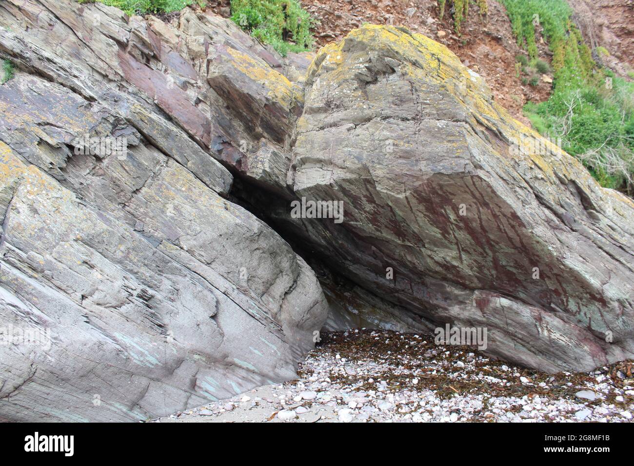 Rocks stones pebbles sand at the beach Stock Photo