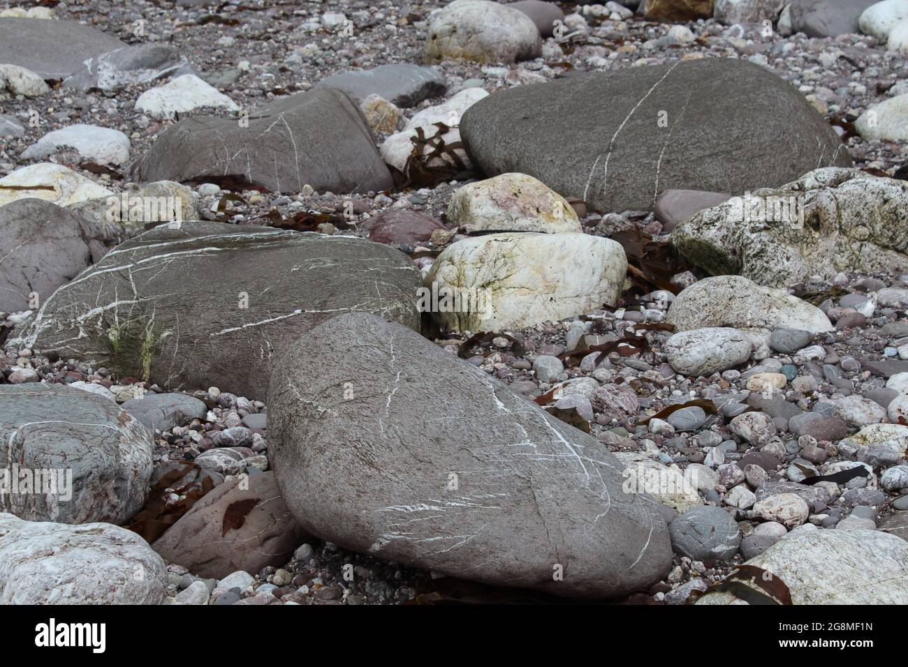 Rocks stones pebbles sand at the beach Stock Photo