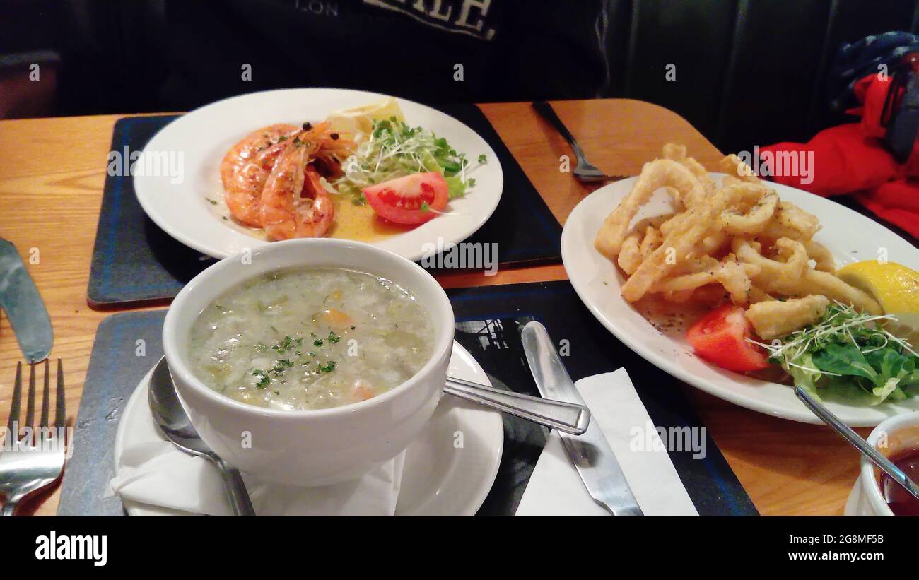 Prawns and calamari rings sea food dish with soup Stock Photo