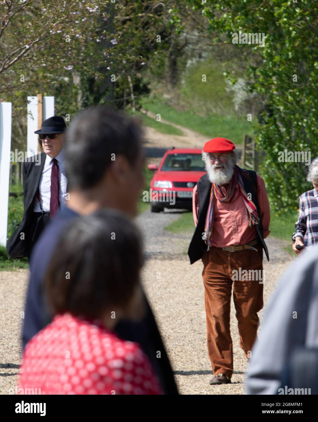 Older man wearing a bright red cap at the Alde Valley Spring festival in Great Glemham Suffolk and 2018 Stock Photo