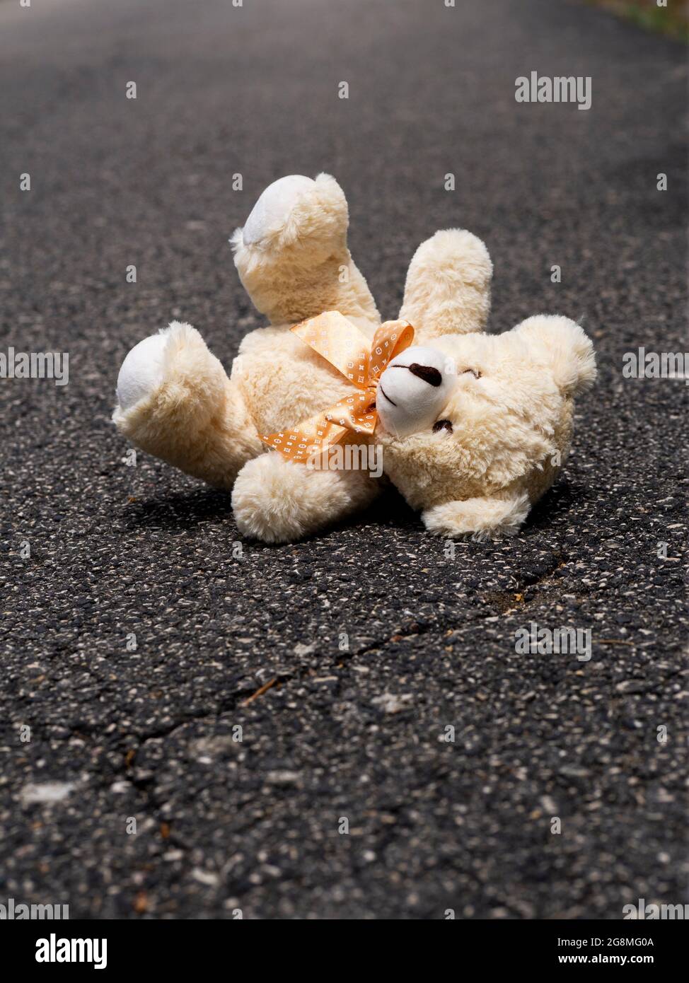 Book cover concept - Childhood - Back view of teddy bear on the street Stock Photo