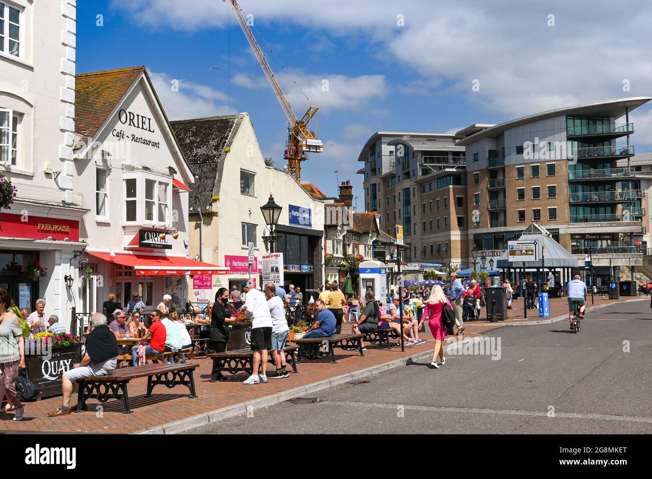 Poole, Dorset - June 2021: People eating outside pubs on the waterfront ...