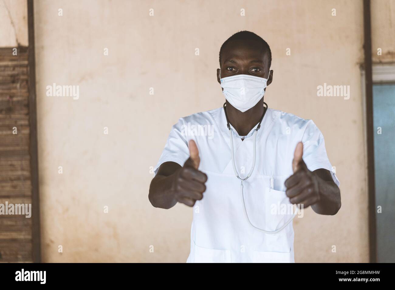 This is an image of an African nurse doctor showing thumbs up to encourage wearing face masks. Stock Photo