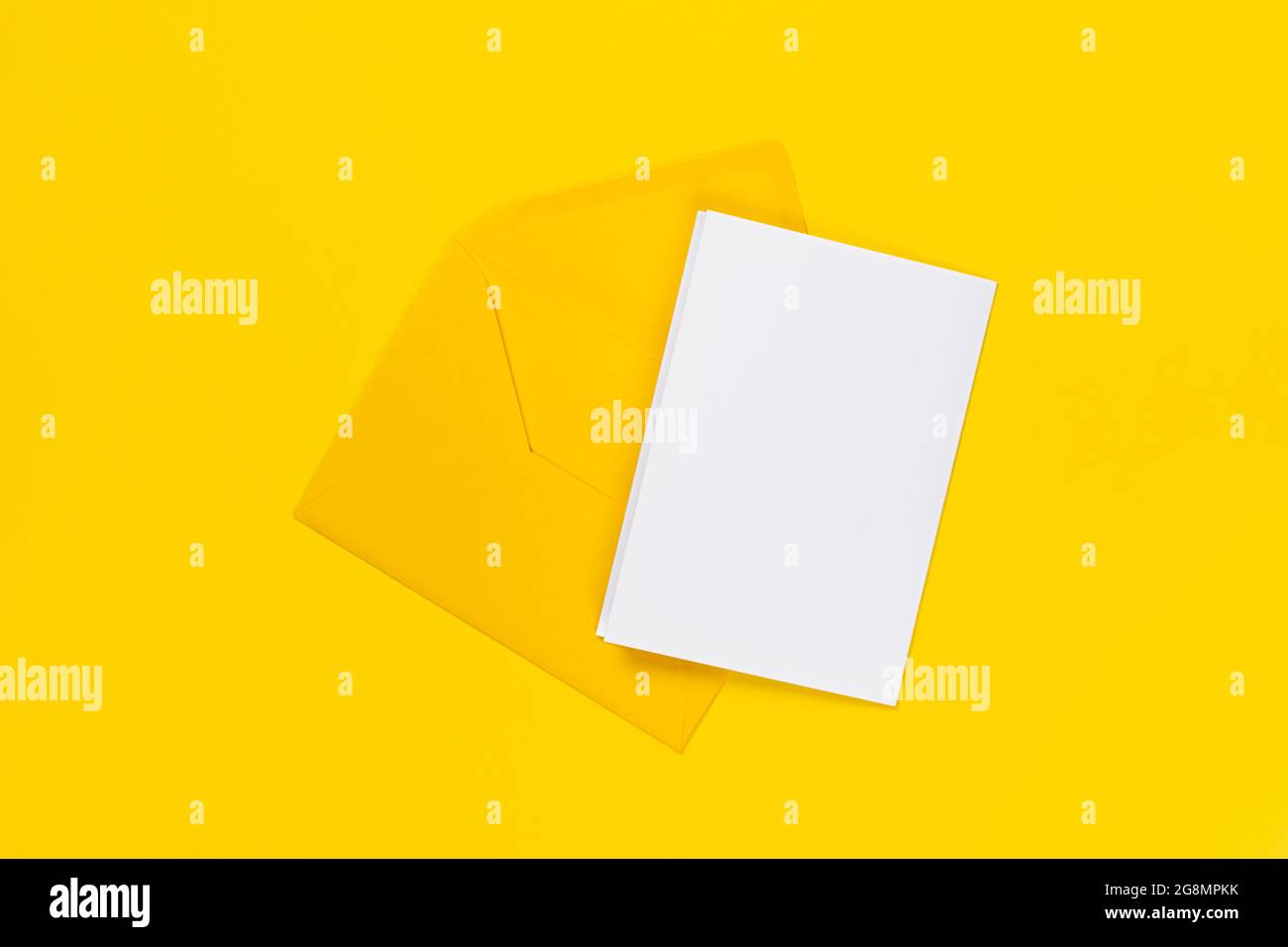 Blank white card with yellow envelope isolated on yellow background ...