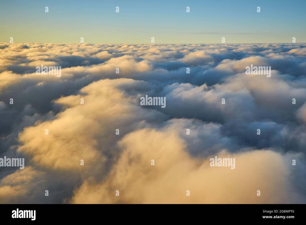 Spectacular view of a sunset above the clouds from airplane window ...