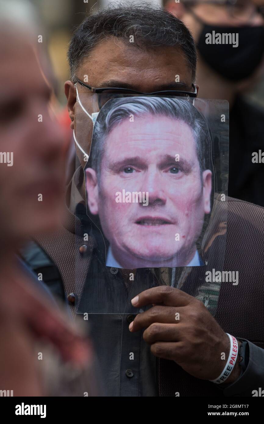 London, UK. 20th July, 2021. Suspended Labour Party member Mehmood Mirza holds an image of Sir Keir Starmer during a protest lobby by supporters of left-wing Labour Party groups outside the party's headquarters. The lobby was organised to coincide with a Labour Party National Executive Committee meeting during which it was asked to proscribe four organisations, Resist, Labour Against the Witchhunt, Labour In Exile and Socialist Appeal, members of which could then be automatically expelled from the Labour Party. Credit: Mark Kerrison/Alamy Live News Stock Photo