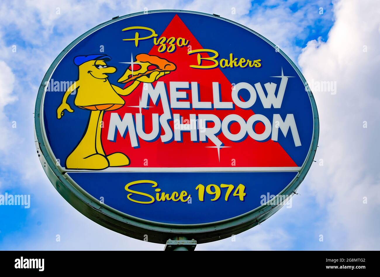 The Mellow Mushroom sign features artwork of a mushroom character eating a slice of pizza, July 20, 2021, in Mobile, Alabama. Stock Photo