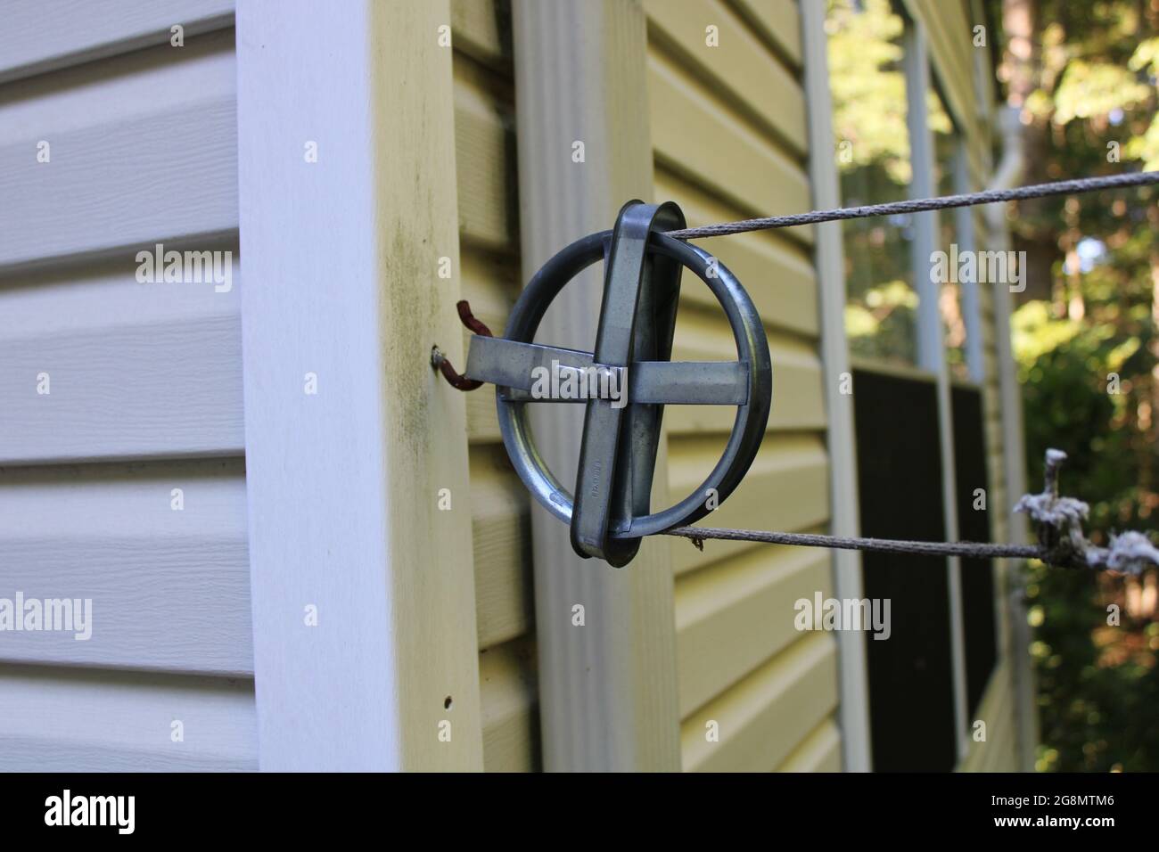 A Common Clothesline Wheel Attached to a House Stock Photo Alamy