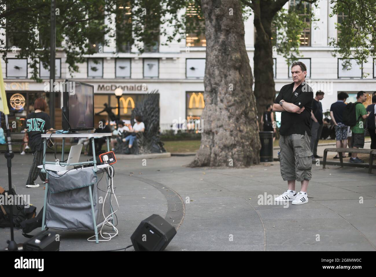 London, UK. 21st July, 2021. A passerby stop to watch the documentary. Hongkongers in London gathered on the 2nd year anniversary of the 721 Yuen Long Mob Attack to screen the documentary of the events. Credit: SOPA Images Limited/Alamy Live News Stock Photo