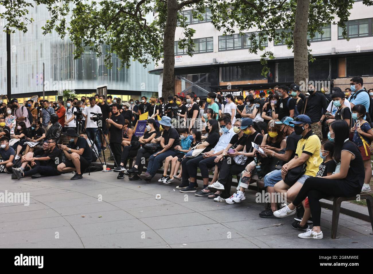 London, UK. 21st July, 2021. Protesters are seen watching the documentary during the demonstration. Hongkongers in London gathered on the 2nd year anniversary of the 721 Yuen Long Mob Attack to screen the documentary of the events. Credit: SOPA Images Limited/Alamy Live News Stock Photo