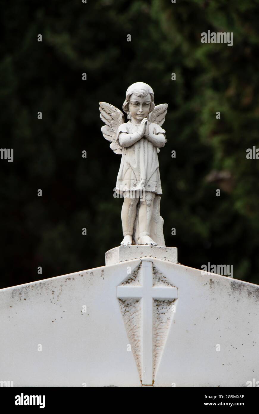 Small statue of a little angel girl with the wings at the gravestone at the old cemetery in Dalmatia, Croatia, close up Stock Photo