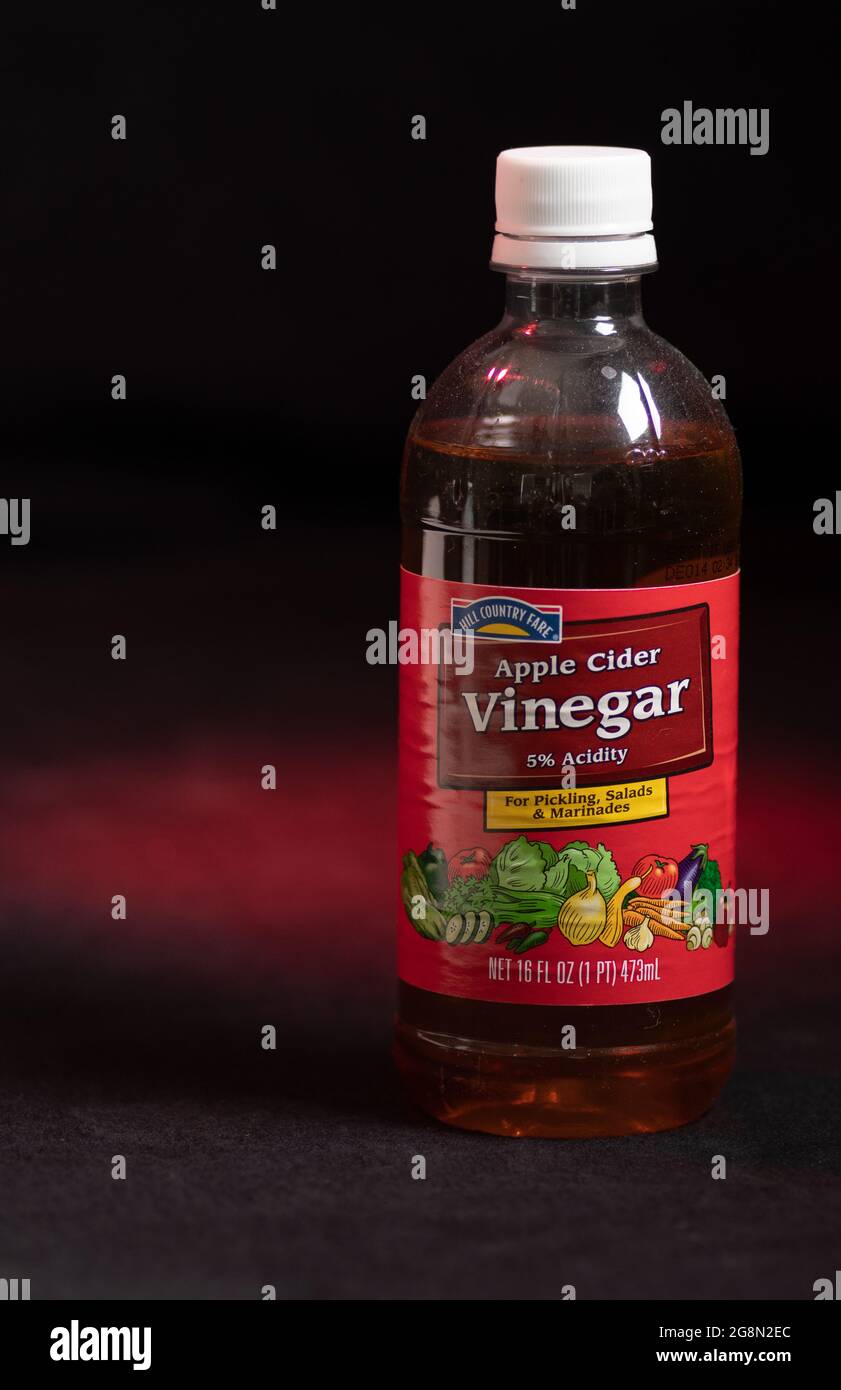 Bottle of apple cider vinegar liquid used as a health supplement on