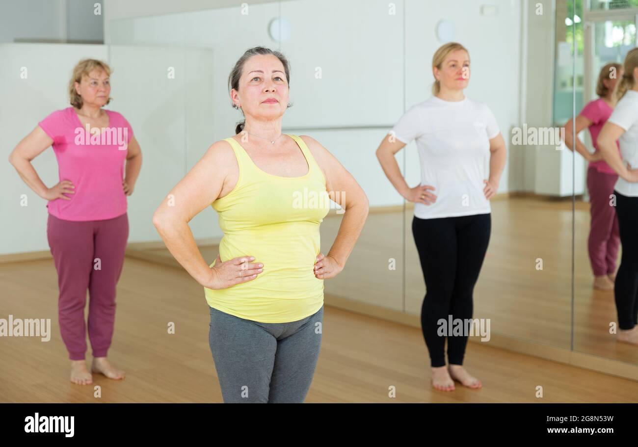 Three women are exercising in a gym Stock Photo