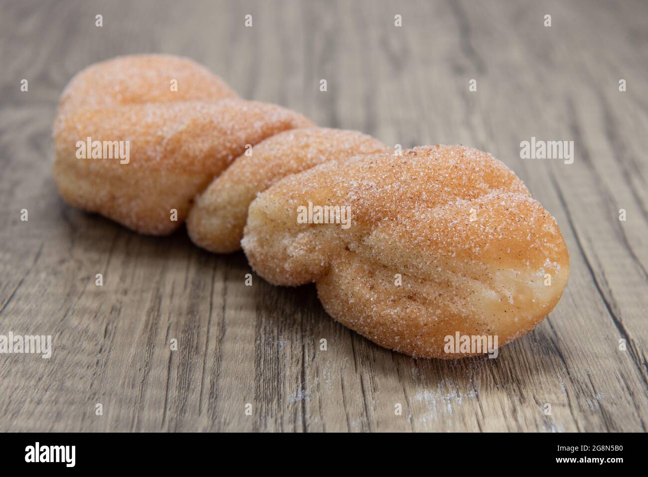 Sugar twist donut is textured with sugar coating for a sweet treat delight. Stock Photo