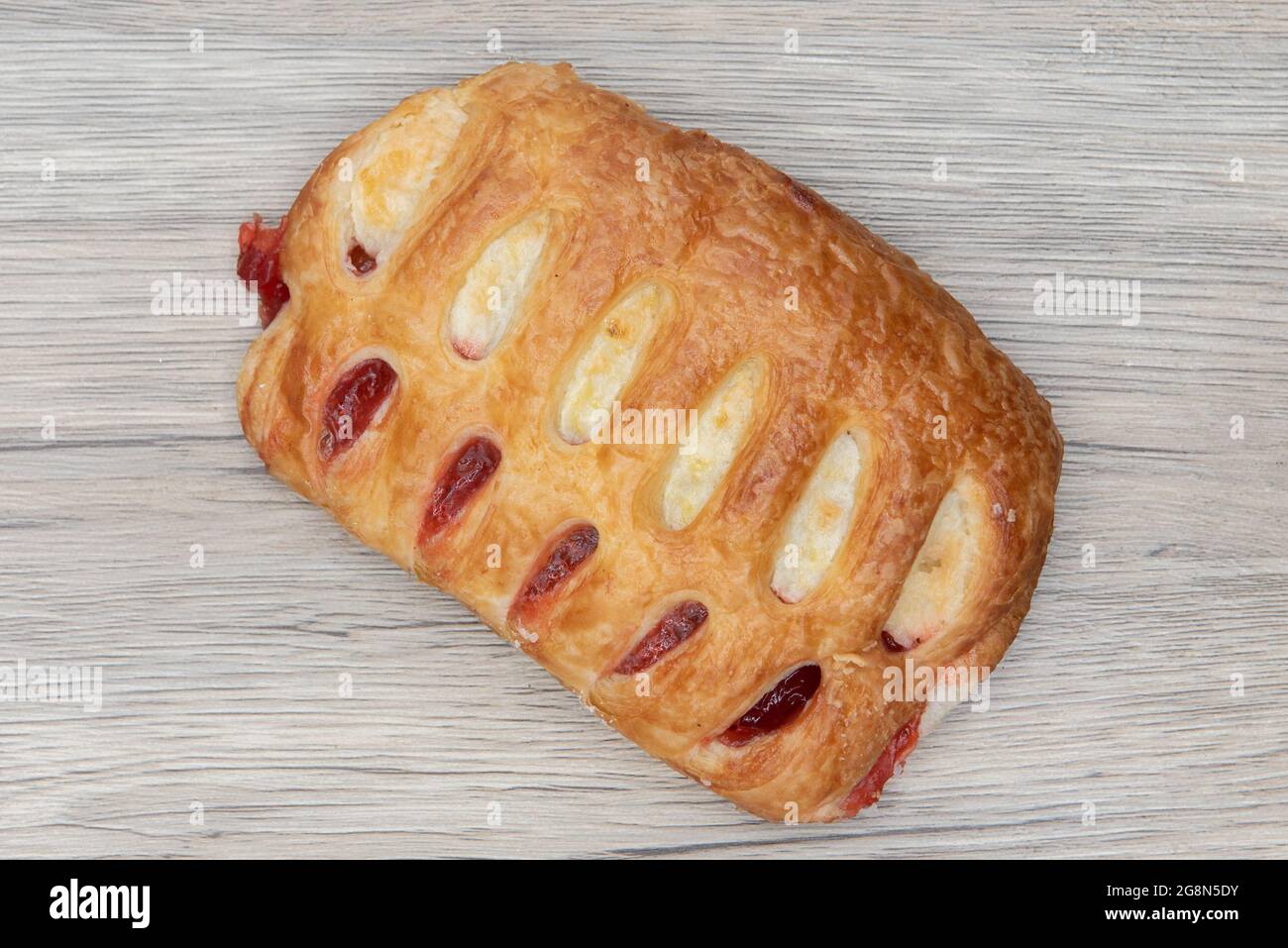 Overhead view of ham and cheese croissant sandwich is textured with flakey crust for a breakfast treat delight. Stock Photo