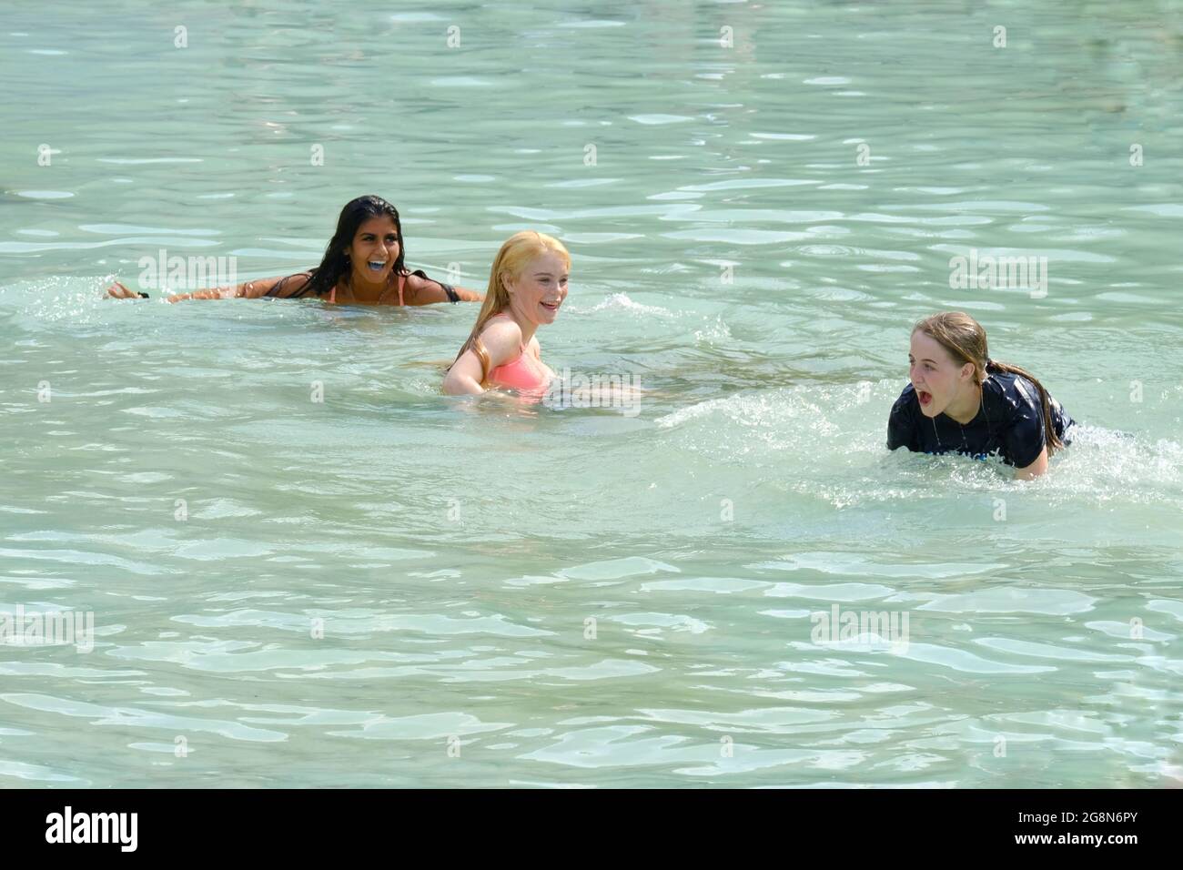 Teenagers take a dip in Trafalgar Square fountains during the recent heatwave when the Met Office issued an extreme heat warning. Stock Photo