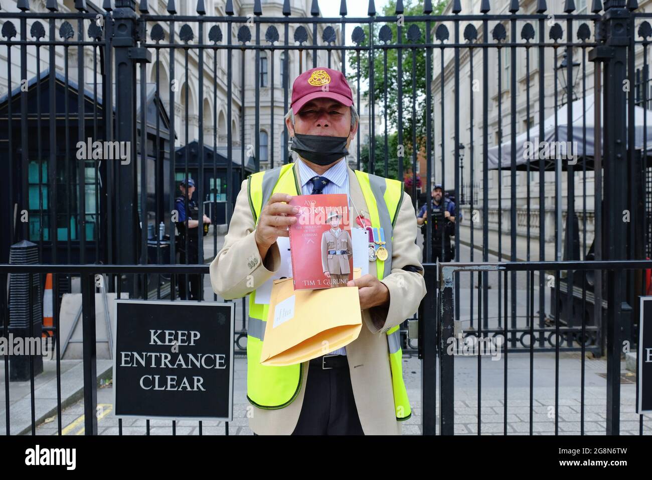 A Gurkha veteran delivers a letter and book to Downing Street where a protest took place for pension parity in line with their British counterparts. Stock Photo